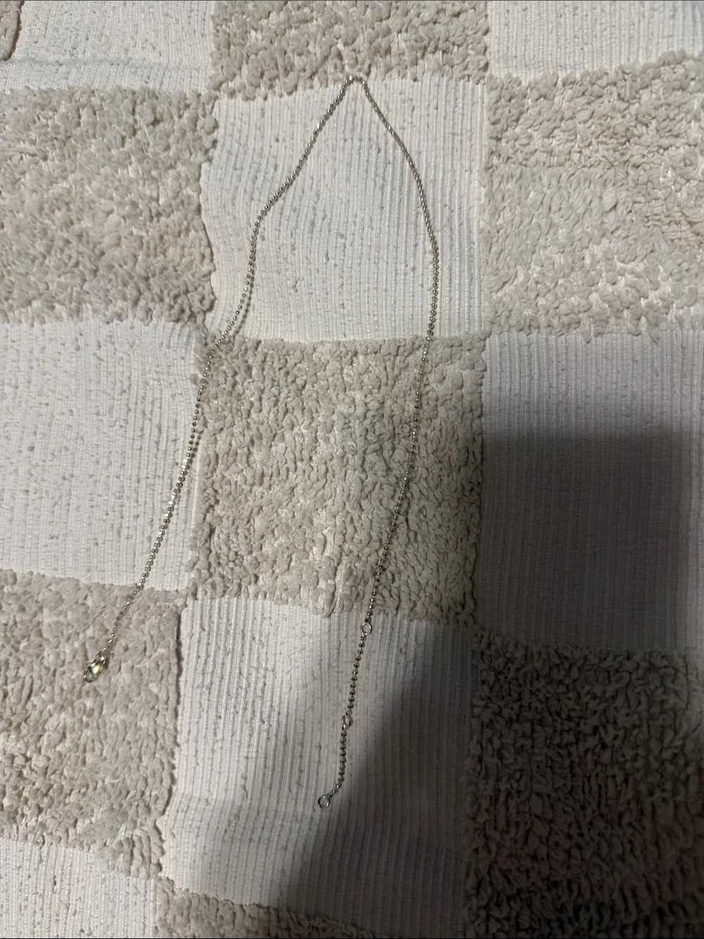 Argento Vivo Silver Tone Chain Necklace on Cream Check Towel